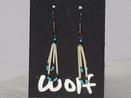 Two short quills and the two long quills all connected with Turquoise and Navy blue size thirteen cut glass beads. Ear attachment is French Hooks